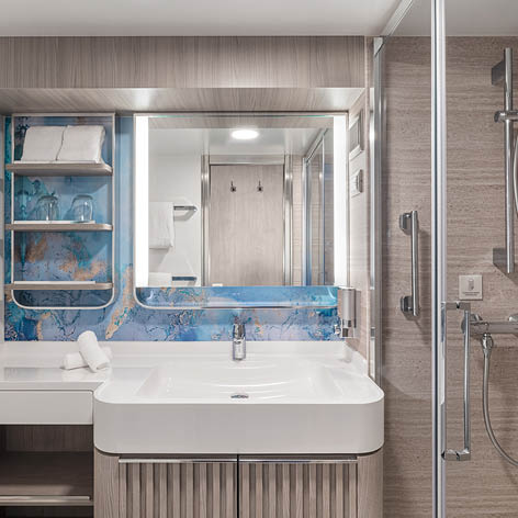 A bathroom with a sink, mirror, and shower. Description generated by AI