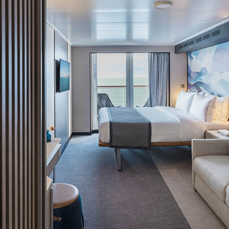 A bedroom with a bed and a couch. Description generated by AI