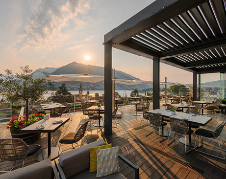 A patio with tables and chairs. Description generated by AI