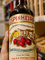 PORTO, PORTUGAL: Bottle of popular cherry liquor Ginja in the hands of the buyer of an alcohol store on 18 May, 2019. Portuguese language has 250 million total speakers