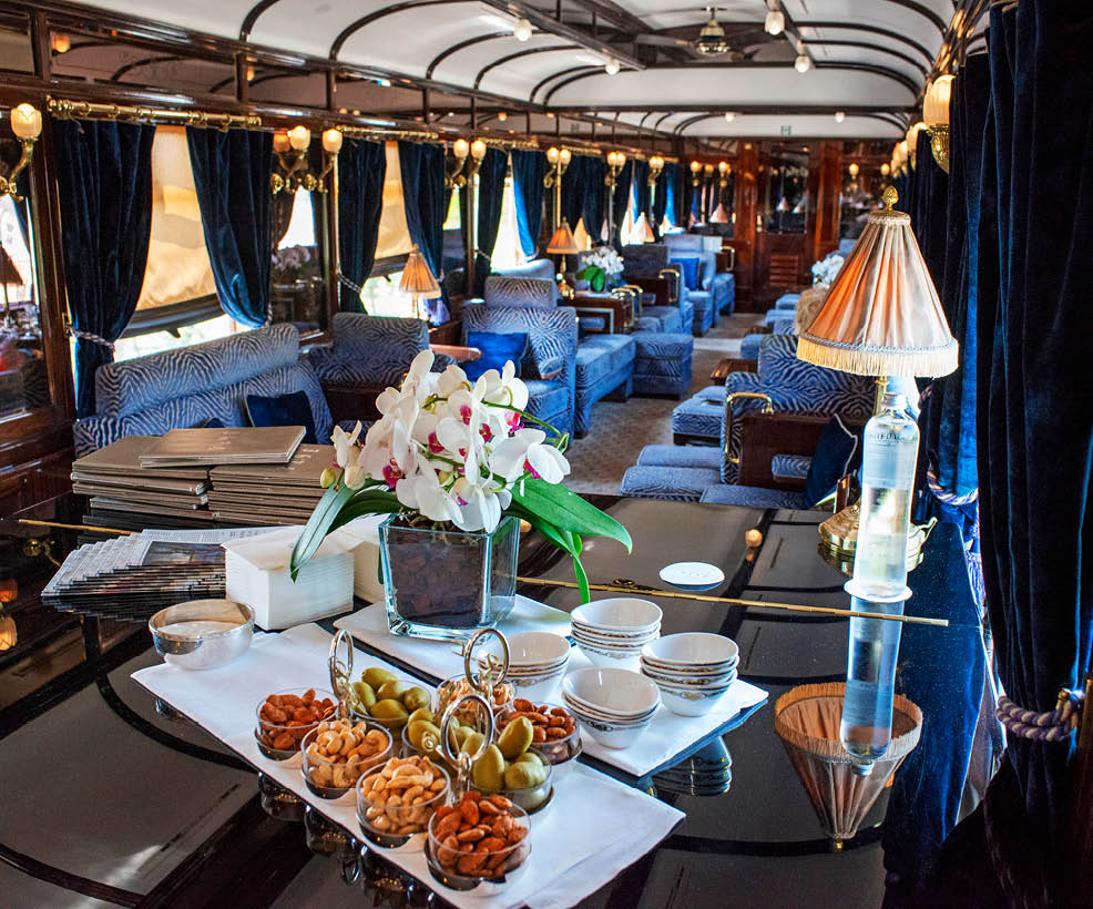 The art deco bar lounge wagon of the train Belmond Venice Simplon Orient Express luxury train.   An icon of art deco design. Rekindle the romance of the rails as you travel between Europe’s most captivating cities. The Venice Simplon-Orient-Express, or VSOE, is a private luxury train service from London to Venice and other European cities. It is currently owned by Belmond, which operates 45 luxury hotels, restaurants, tourist trains and river cruises in 24 countries. It was agreed in December 2018 for the service to be acquired by LVMH 