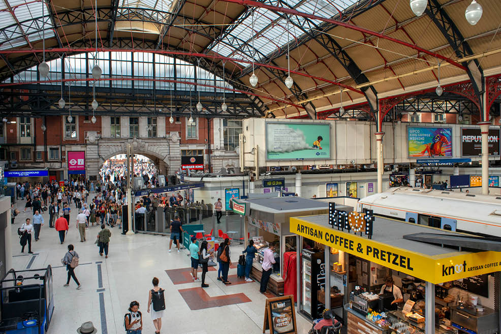 British rail London Victoria train station platform with travelers London England. Originally opened in 1860, today Victoria station is one of London's busiest central terminus station. It connects to the Victoria Coach Station and a London Underground tube station. Victoria station is named after nearby Victoria Street.   