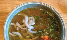 BARLEY UDON, SAKE WASHED SALMON ROE, GRILLED FISH BONE OIL,­ CHARRED BROCCOLI FLORETS, CROWBERRY TARE, and CHIVES © DRIFT Travel Magazine