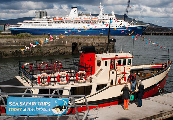 The Red Hulled Tourist Boat Mona Moored in The River Lagan in Belfast Northern Ireland United Kingdom UK. The Lagan Boat Company run two different tours, each travelling in different directions on the Lagan River. 