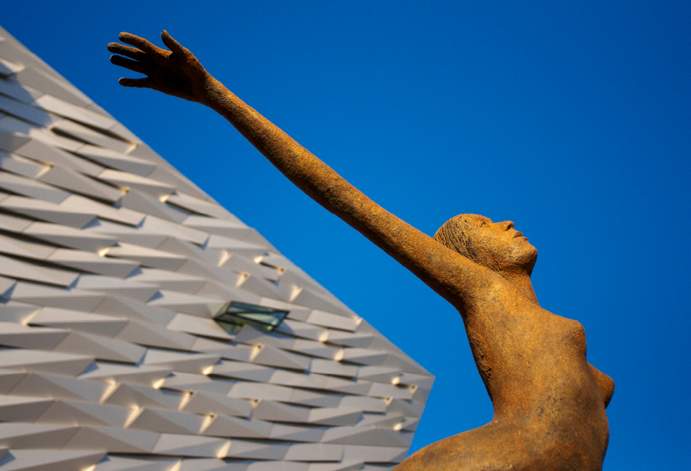 Rowan Gillespie's sculpture Titanica in front of the Titanic museum in Belfast, Northern Ireland United Kingdom UK. A sculpture entitled 'Titancia' marks the entrance to the Titanic Belfast Experience, Northern Ireland, UK. 