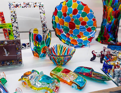 Colorful souvenirs from famous Murano glass on showcase of gift shop in Venice..