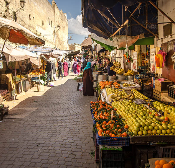 FEZ, MOROCCO - Februari 25, 2018: Fruit marking in the old Medina of Fez city dutring a sunny day