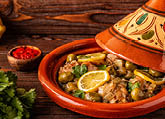 Traditional Moroccan chicken tagine with olives and salted lemons, selective focus 