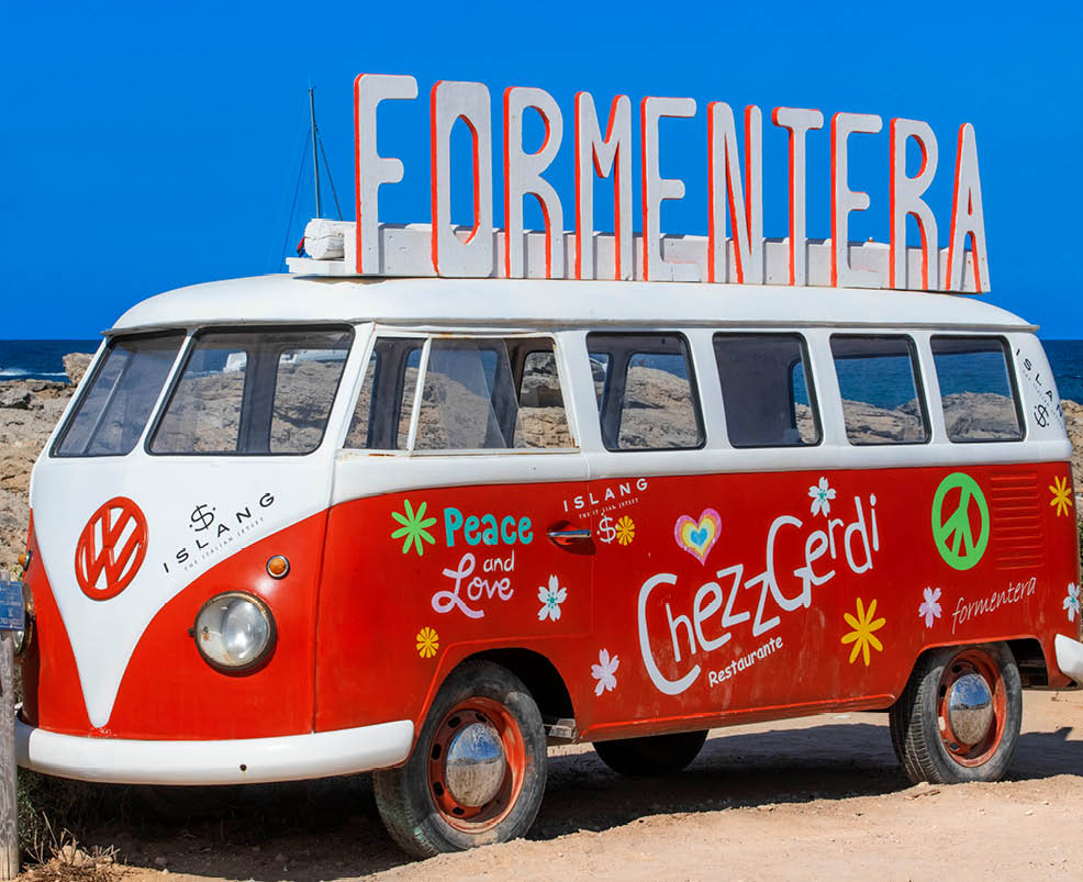 A red and white bus with the words “FERMENTERA" written on the top. AI generated content