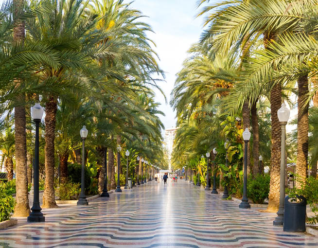 A tree-lined sidewalk with a red and black checkered pattern. AI generated content