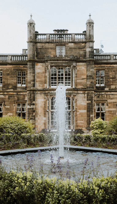 A large building with a fountain in front of it. AI generated content