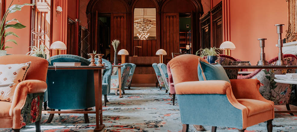 A large room with a high ceiling and a red color scheme. The room contains several chairs, a dining table, and a potted plant. AI generated content