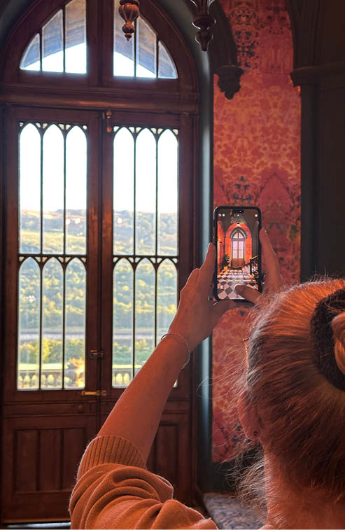 A woman is taking a picture of a doorway with a cell phone. AI generated content