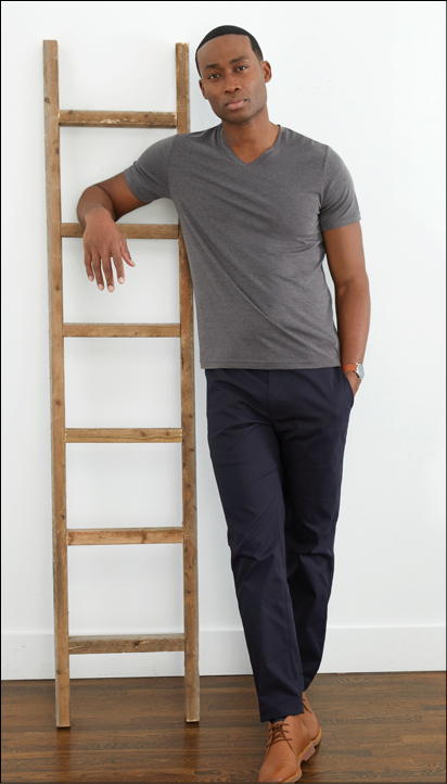 A man wearing a grey shirt and blue pants is standing next to a ladder. AI generated content