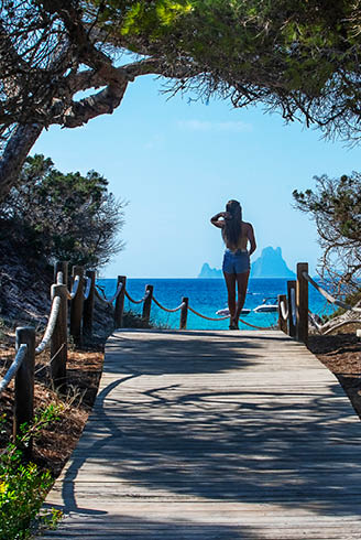 A person is standing on a pier, looking out at the ocean. AI generated content