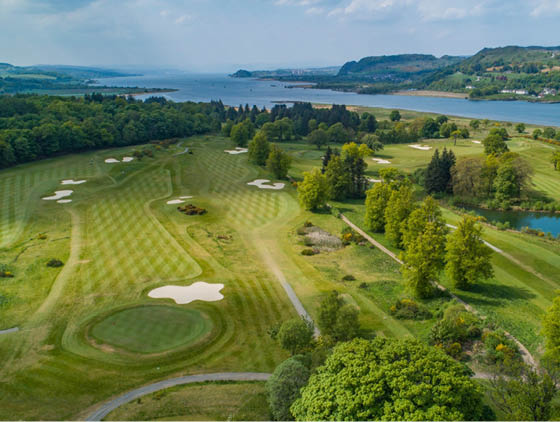 A lush green golf course with a lake in the background. AI generated content