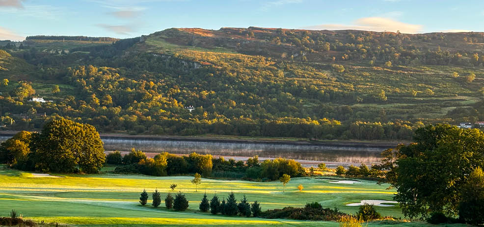 A green golf course with a large hill in the background. AI generated content