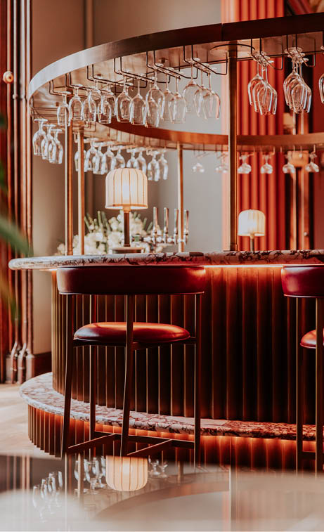 A bar with a circular counter and a row of red stools. AI generated content
