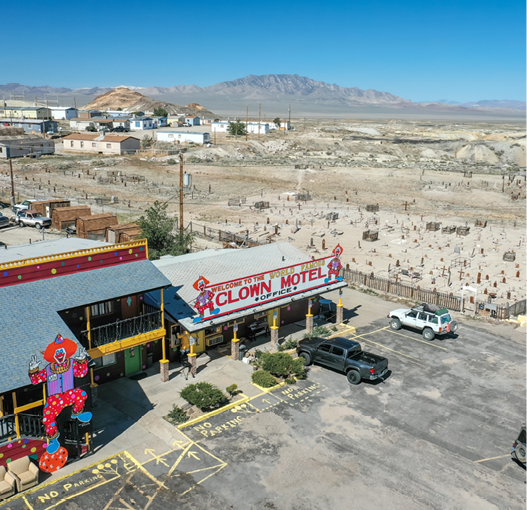 TONOPAH, NEVADA, UNITED STATES - May 25, 2020: The Clown Motel, a popular themed lodge, stands along Nevada's Highway 95 with the city of Tonopah's historic cemetery sitting adjacent 