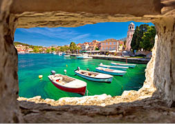 Turquoise waterfront of Cavtat view through stone window, Dalmatia, Croatia