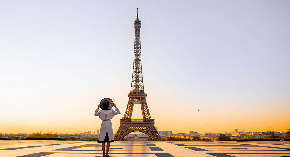 Famous square with great view on the Eiffel tower and woman standing back enjoying the view in Paris