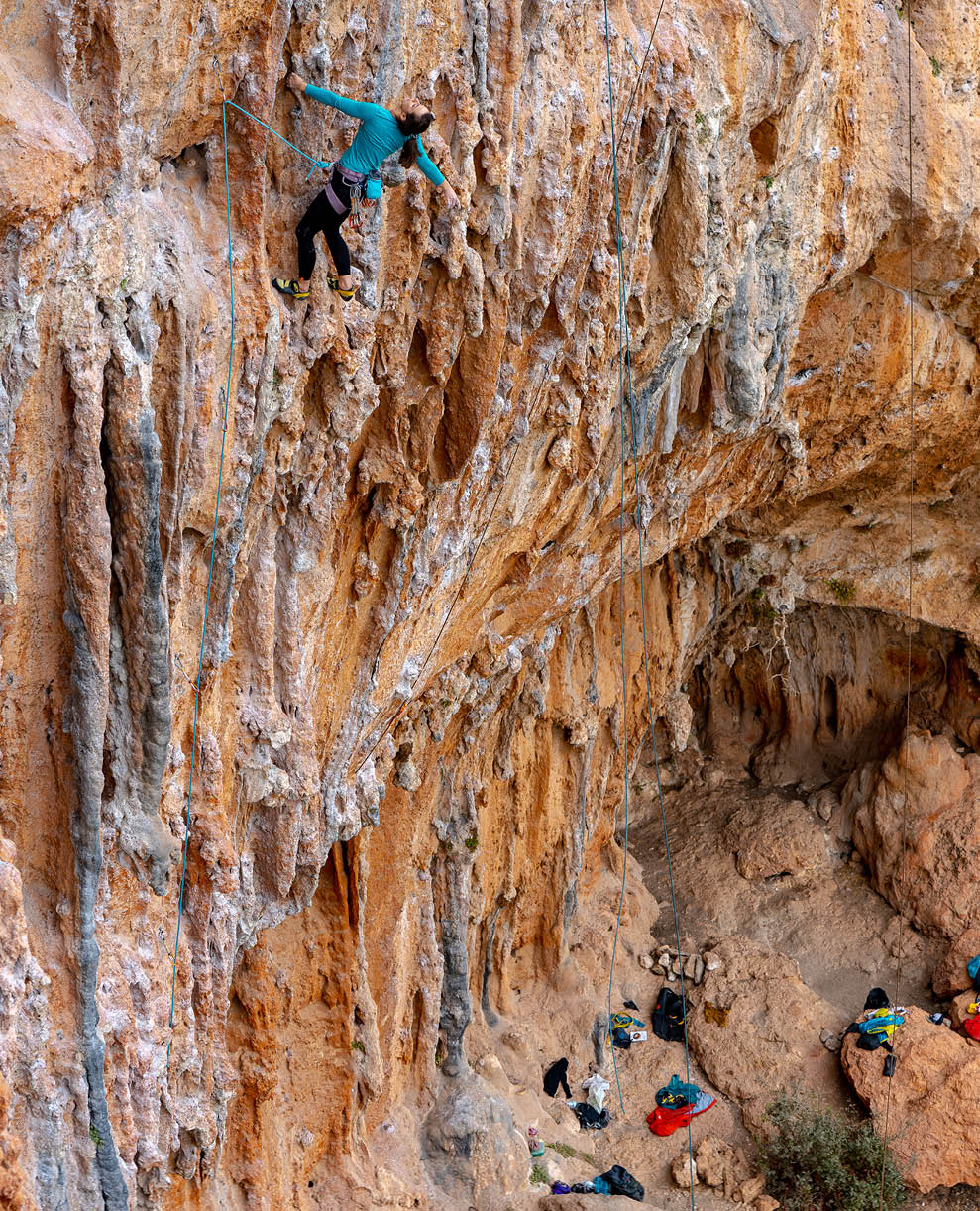 A rock climber rests while climbing the steep limestone of Leonidio, Greece. Leonidio is a major sport climbing destination on the coast of Greece, about 4 hours from Athens.