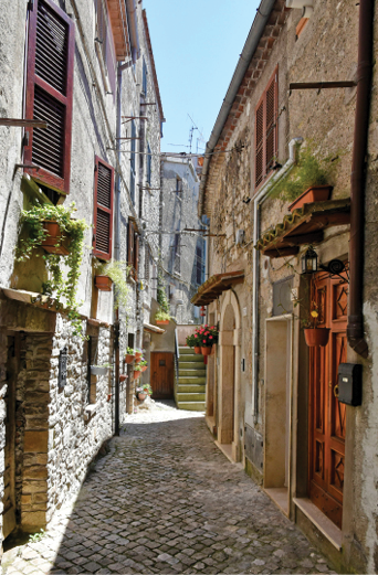 A narrow street between old medieval buildings in Bracciano, Lazio, Italy