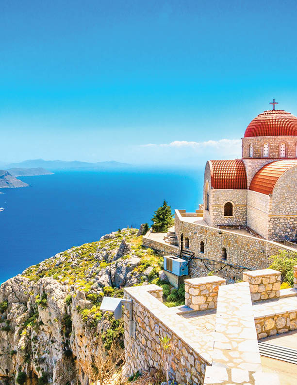 Amazing view on remote church with red roofing on the Cliff of the sea, Greece