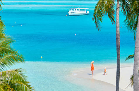 Three year old toddler boy on beach with mother. Summer family vacation at Maldives.