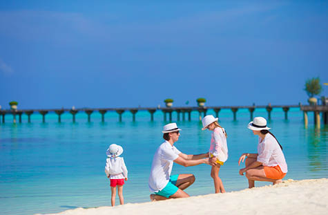 Happy beautiful family on a beach during summer vacation
