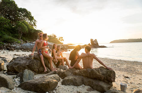 Group of happy friends on a tropical island having fun - Young adults playing together on the beach, summer vacation on a beautiful beach